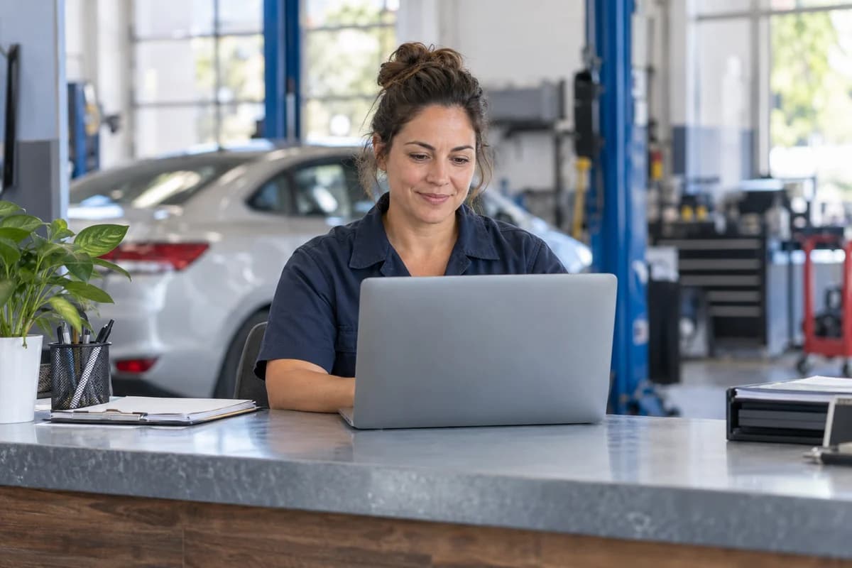 Auto shop owner working at her workshop reception desk